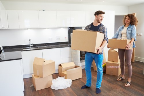 Office relocation setup with desks, chairs, and organised moving boxes