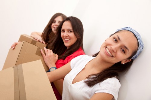 Removalists handling furniture on a residential street