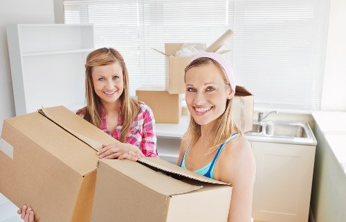 House movers unloading boxes into a new property in Wood Green
