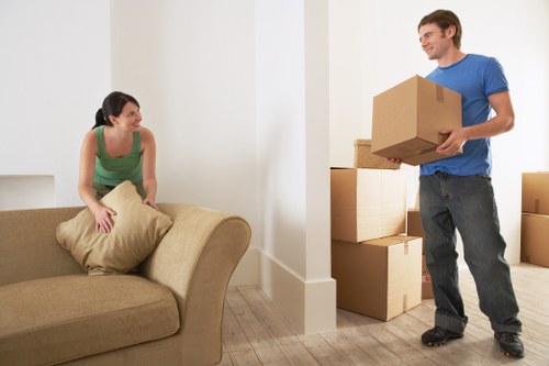 Packed moving boxes and furniture prepared for transport in Wood Green